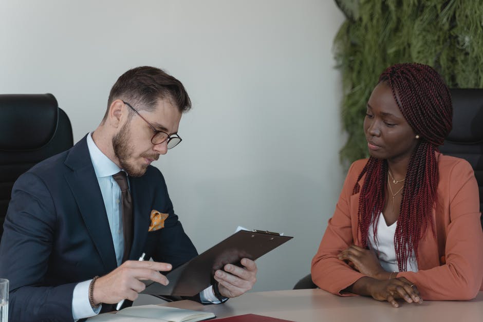 White interviewer speaking with black job applicant